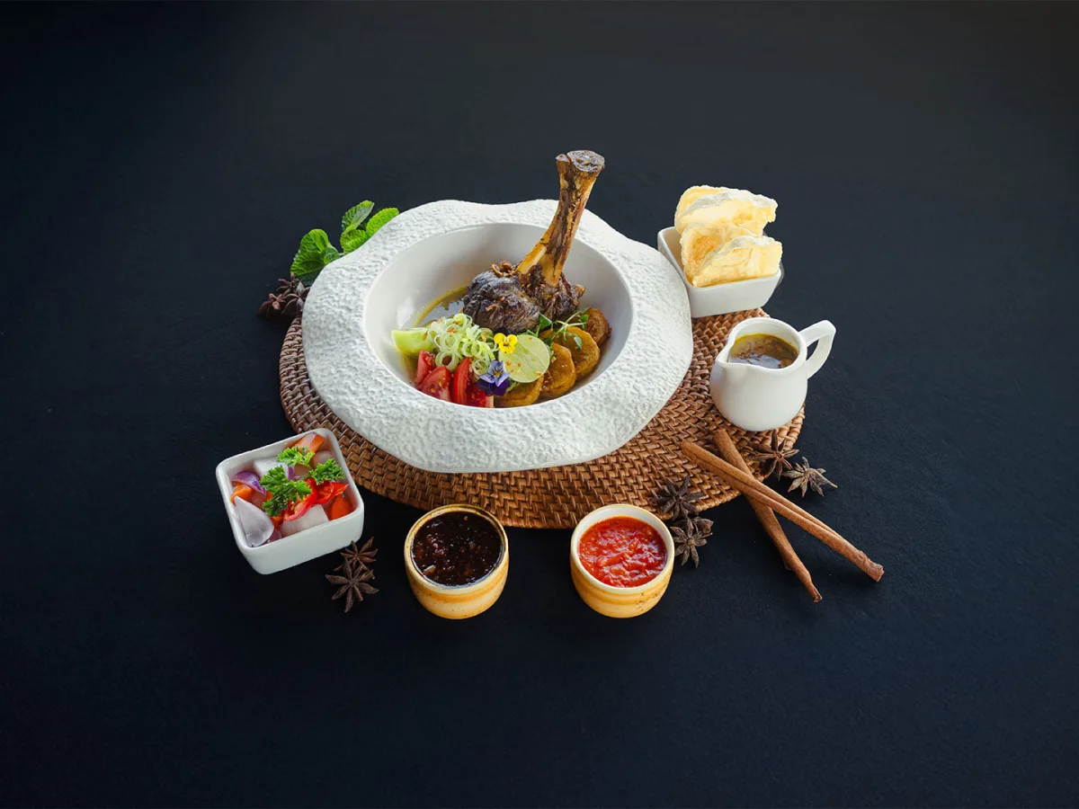 A chef adds the finishing touches to a plated dish at Nandini Jungle.