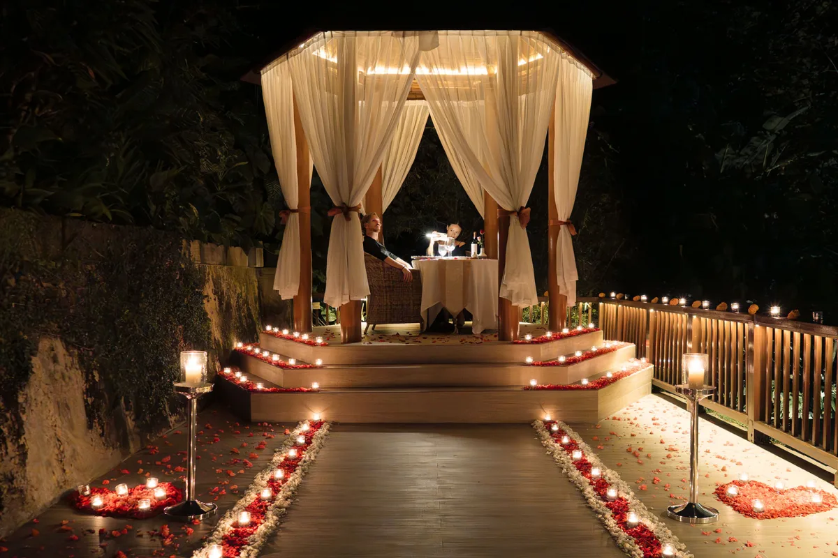 Romantic candlelit dining by the chapel at Nandini Jungle by Hanging Gardens in Bali.